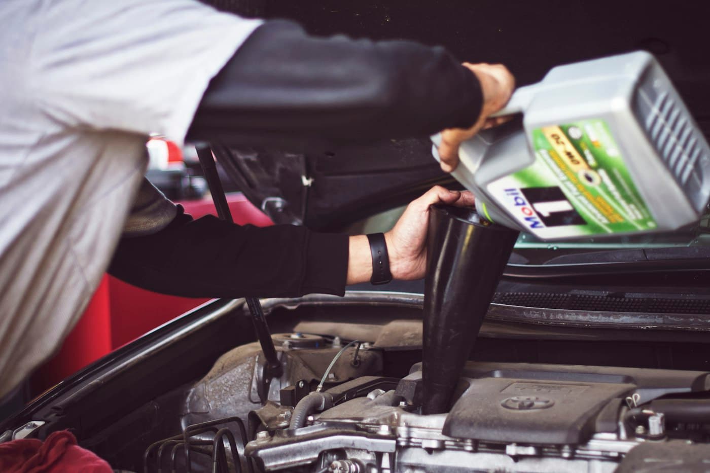 Oil being poured during a car service